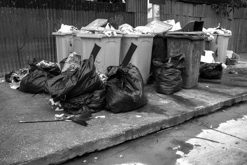 Team preparing for safe rubbish removal with protective equipment and waste bags